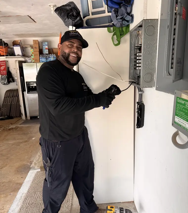 John, licensed electrician and owner of Switch It Up Electric LLC, working in an electrical panel in Southwest Florida