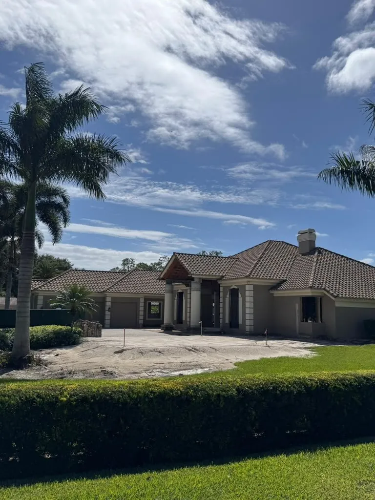 Custom tile-roof home under electrical construction in Southwest Florida by Switch It Up Electric